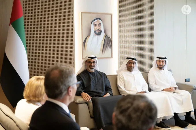 Sheikh Khaled bin Mohamed bin Zayed Al Nahyan seated in a meeting room with members of Cleveland Clinic’s executive management and UAE officials